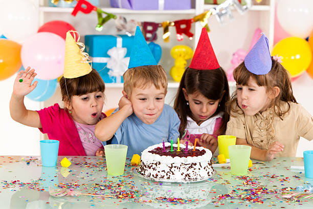 Kids around a birthday cake