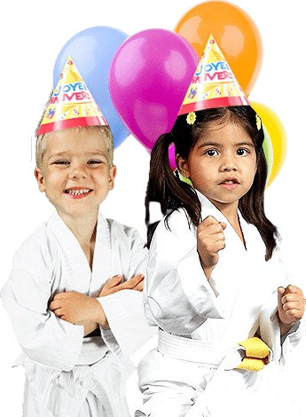 Two kids in karate uniforms with birthday hats and balloons